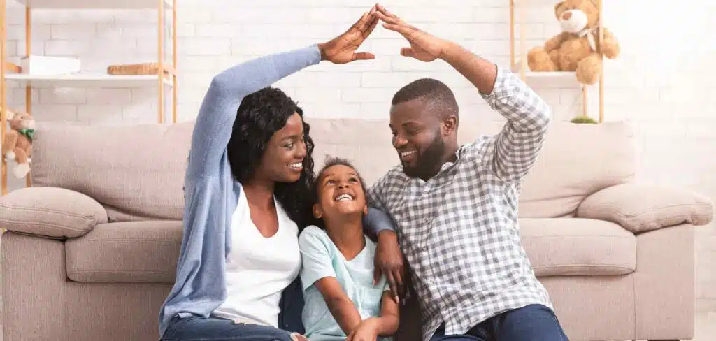 Adults making a roof with their arms over a girls head