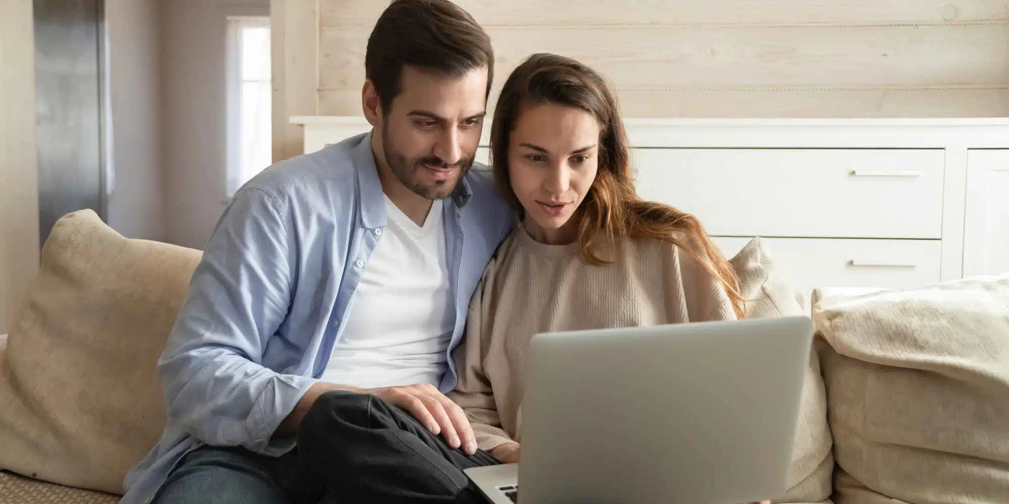 Couple at laptop asking the question Are Foster Carers Self-Employed?