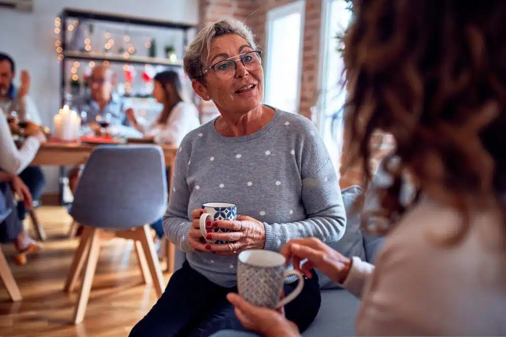 Two women chatting at a fostering event in a cafe